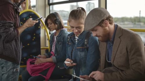 Young Adults on a Bus Using Technology