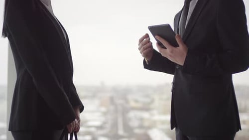 Business People Discuss Tablet in Urban Office