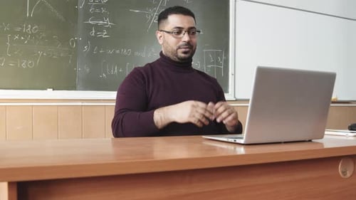 Teacher Explaining Math Lesson Online with Laptop