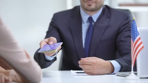 Man in Suit Handing Over a Passport