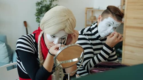 Mimes Applying White Face Makeup at Home