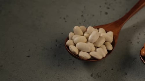 Close Up of White and Brown Beans in Spoons