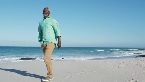 Senior man walking besides the beach