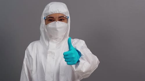 Woman in Hazmat Suit Gives Thumbs Up