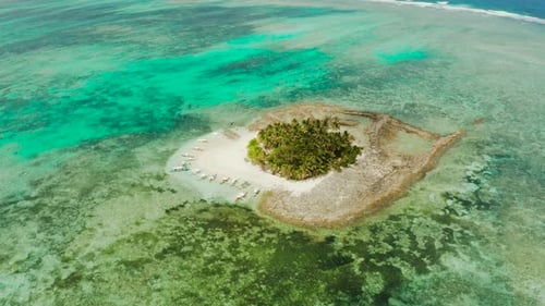 Tropical Guyam Island with a Sandy Beach and Tourists