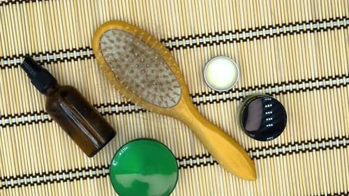 Hairbrush with Hair Strands Surrounded by Products