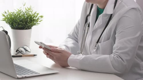 Female Physician Woman Doctor Using Mobile Phone Clinic Office Room Smartphone