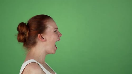 Young Woman Screaming on Green Chromakey Background