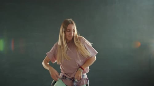 Young Woman Dancing Energetically Indoors