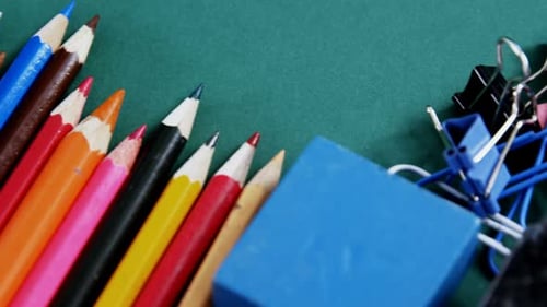 School supplies arranged on green background
