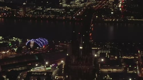 AERIAL: Beautiful Wide Shot Over Cologne Germany at Night Time with City Lights