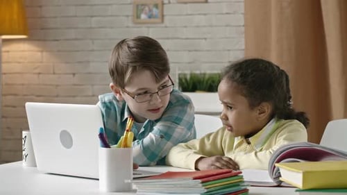 Children Learning Together Using Laptop at Home
