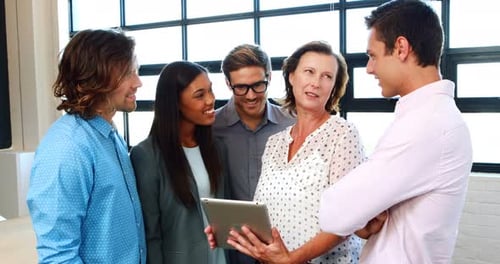 Business Colleagues Discussing Ideas Using a Tablet
