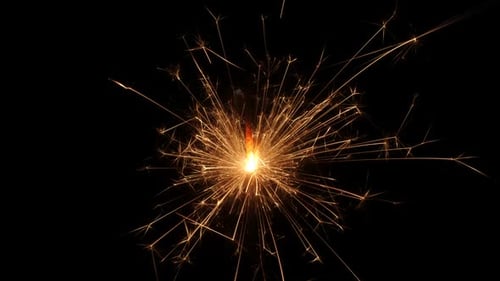 Sparkling Sparkler Emitting Golden Sparks in the Dark