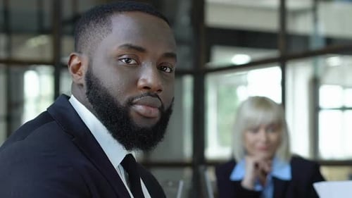 Stern Man with a Beard in a Suit