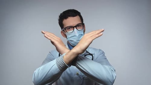 Doctor Wearing Mask Makes Rejection Gesture