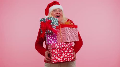 Senior Woman Holding Christmas Presents and Smiling