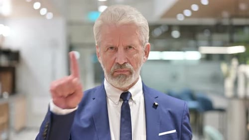 Senior Old Businessman Saying No with Finger Gesture