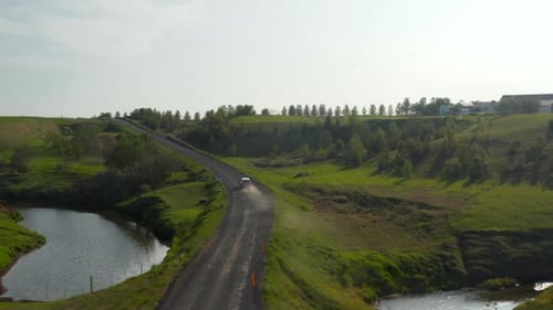 SUV Driving Down a Dusty Rural Road