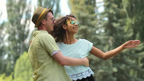 Male and Female Attracted to Each Other Dancing Together, His Arms on Her Waist
