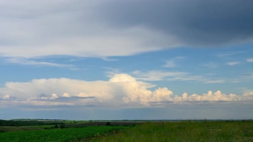 Time-Lapse of Dramatic Clouds Over a Green Field