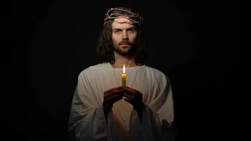 Homem igual Jesus na coroa de espinhos soprando na vela, pecados de pessoas mortais, Deus