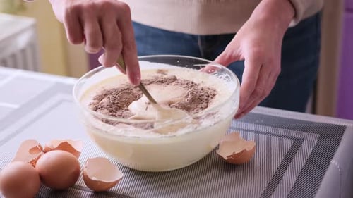 Woman mixing baking ingredients in bowl