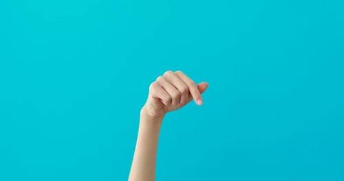 Hand Tapping Gesture Against Blue Background