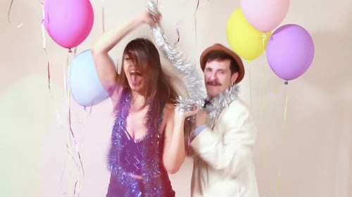 Happy couple having great time dancing in photo booth