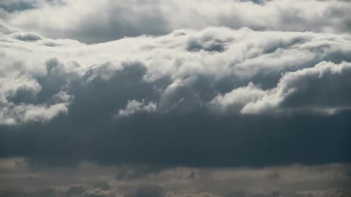 Dramatic Puffy White Clouds Churn in the Daytime Sky