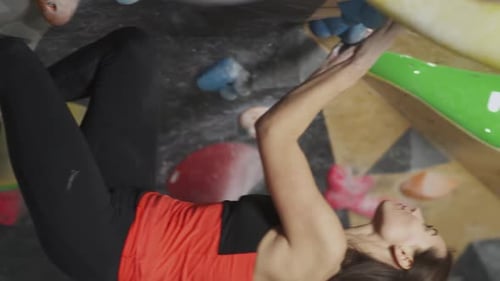 Woman Indoor Rock Climbing on Colorful Wall