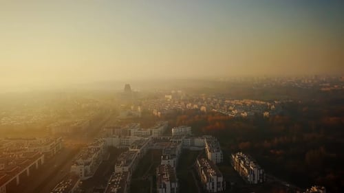 Beautiful cinematic aerial shot of misty sunrise in foggy town in autumn