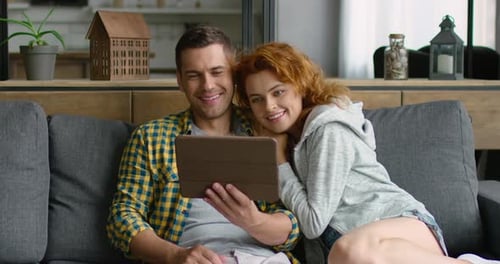 Young Man and Woman Have a Video Chat on Tablet Computer