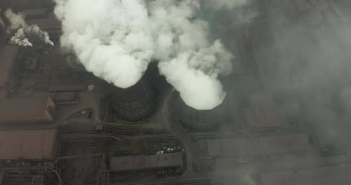 Aerial View of an Industrial Pipe Pollutes the Air Next To People Living in the City. Create a