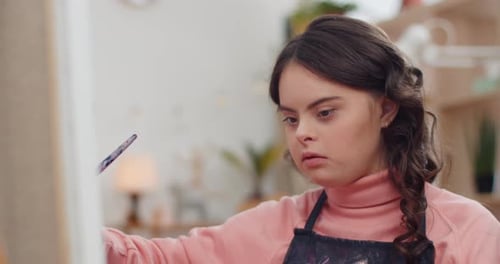 Close Up View of Talanted Teen in Aprone with Down Syndrome Creating Picture in Her room, Beautiful