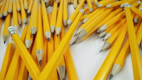 Yellow Pencils Lie Chaotically on a White Background Macro Shot on a Laowa 24Mm