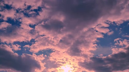 Pink Sunset Clouds Slowly Drift Across Blue Sky