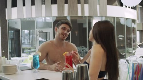 Beautiful Couple Chatting in Spa. Smiling Man Woman Drinking Cocktails at Resort