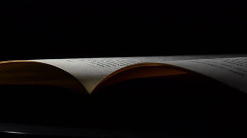 Open Book with Text on Pages in Dark Setting