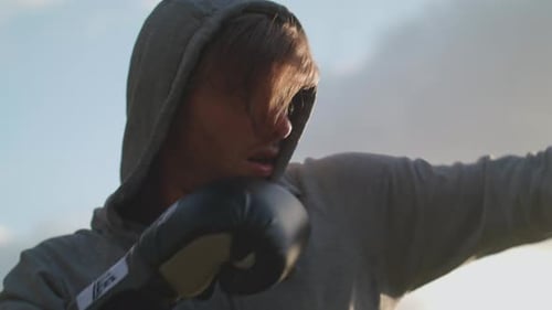 Man Boxing In The Park In The Evening Sun In Slow Motion