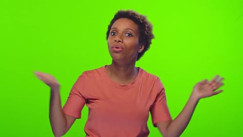 Young African American Woman Suffering From Sweltering Weather Stands in Studio