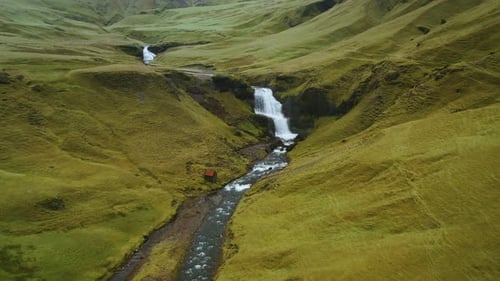 Beautiful Aerial Drone View of Icelandic Landscape with Green Fields and River in Summertime