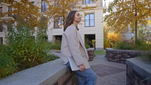 Woman Smiles in Urban Courtyard in Autumn