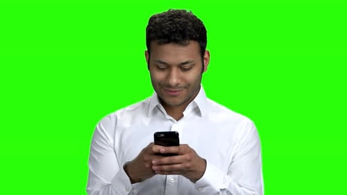 Indian Businessman Typing Message on Mobile Phone
