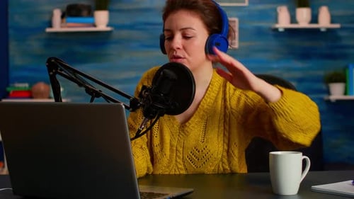 Woman Opens Laptop with Microphone for Video Podcast