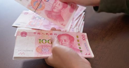 Hands Counting Chinese 100 Yuan Renminbi Banknotes
