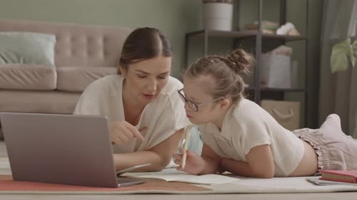 Woman and Child Using Laptop for Education at Home