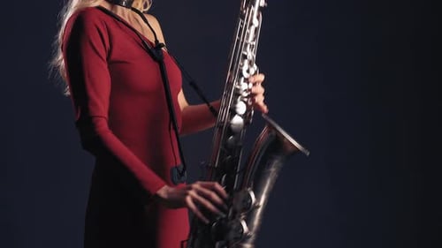 Woman Performing on Saxophone in Elegant Style