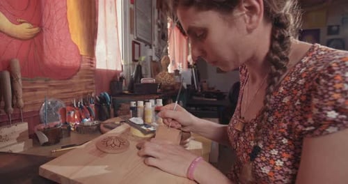 Woman Carving Wood at Her Workshop