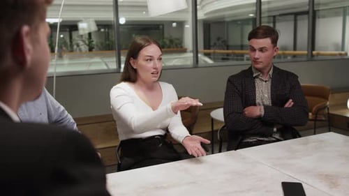 Girl office employee of the financial department tells her colleagues about work